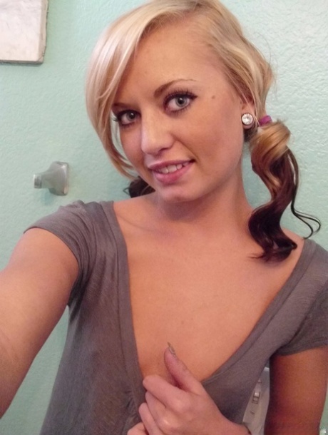 Blonde amateur takes a series of naked selfies in the bathroom mirror