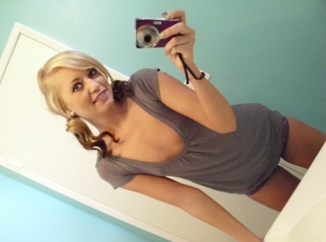 Blonde amateur takes a series of naked selfies in the bathroom mirror
