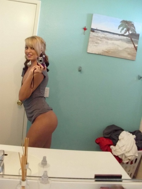 Blonde amateur takes a series of naked selfies in the bathroom mirror