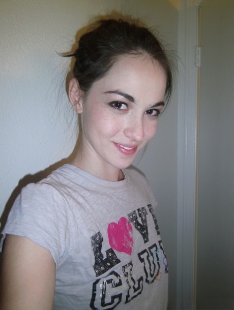 Sexy coed Emily Grey takes a selfie of her small tits and bare bald pussy