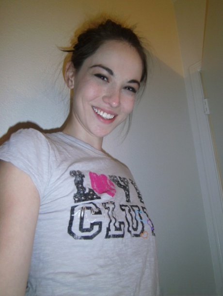 Sexy coed Emily Grey takes a selfie of her small tits and bare bald pussy