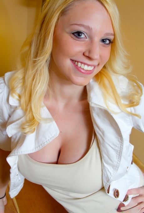Smiley blonde amateur Jeannine Hansen removes her top to flaunt enormous tits