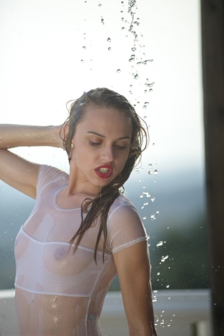 Thin teen in see thru swimsuit gets caught in a torrential downpour on balcony