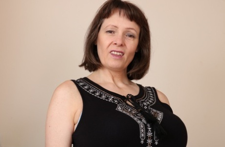 Fat granny slips out of her black dress and undies to air her big old tits