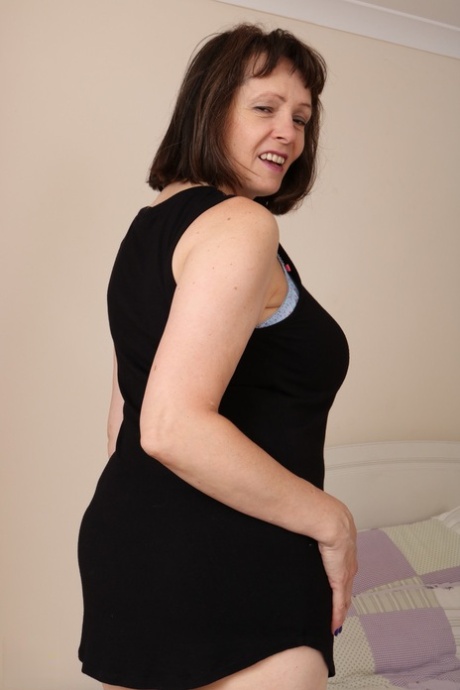 Fat granny slips out of her black dress and undies to air her big old tits