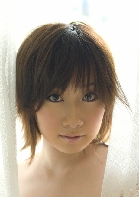 Japanese girl Hanno Nono fondles big naturals while getting mostly naked
