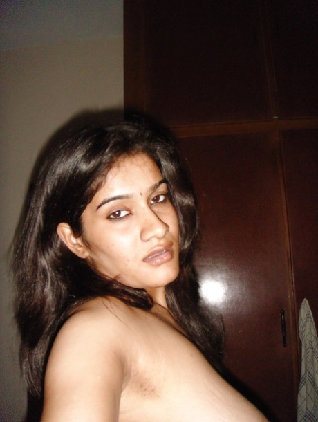 Indian solo girl sucks on the nipples of her big naturals during self shots