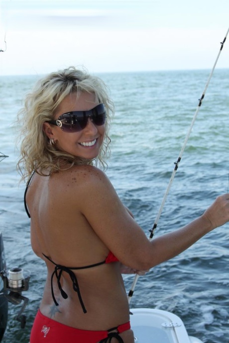 Busty middle-aged blonde Naughty Alysha has sex while on a fishing boat