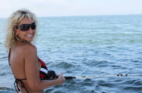 Busty middle-aged blonde Naughty Alysha has sex while on a fishing boat