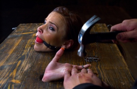 Naked girl is subjected to being covered in hot wax while in bondage
