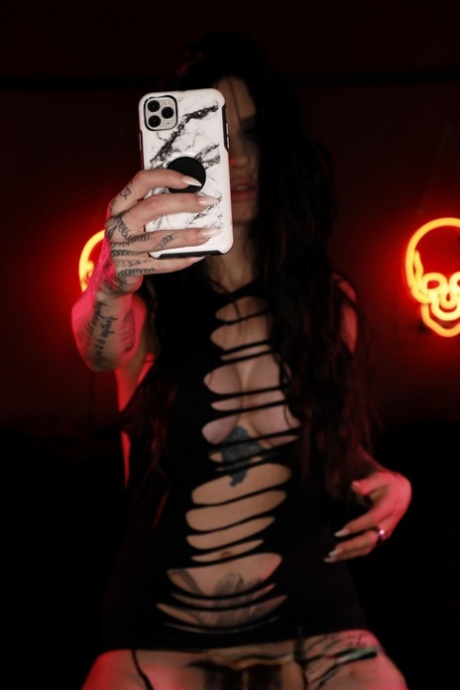 Tattooed brunette Misha Montana takes self shots of her pierced vagina