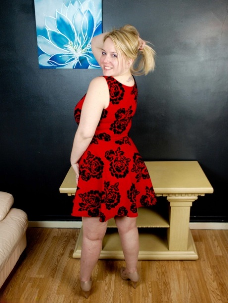 Blonde fatty Sindy Bust gets naked on a table in high-heeled shoes