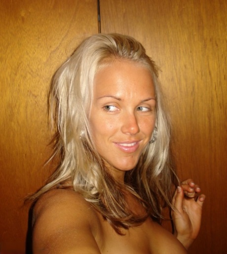 Hot blonde Aussie Jewel displays her big boobs while taking nude selfies