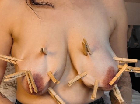 Solo girl Shione Cooper attaches clothes pegs to her big boobs in glasses