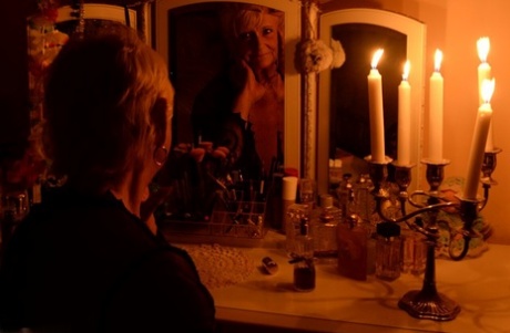 Blonde granny Sparkle stands bare naked after modelling lingerie