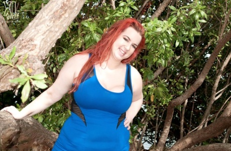 Redhead BBW Amerie Thomas runs water over her big tits after modeling a dress