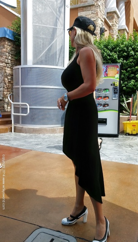 Sweet housewife Sandra Otterson poses in sexy glasses and tight skirt