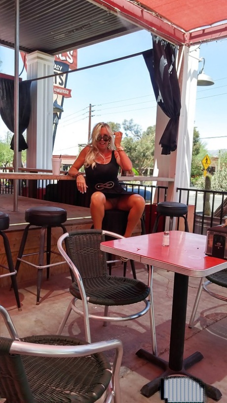 Sweet housewife Sandra Otterson poses in sexy glasses and tight skirt
