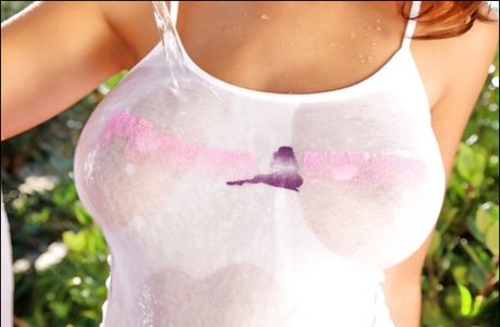 Chesty babe Holly poses outdoors in wet T-shirt and pink short shorts