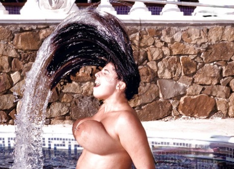 Chubby Euro MILF Kerry Marie frees large pornstar tits from bikini in pool
