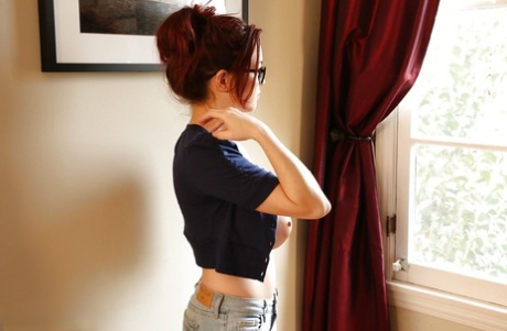 Redhead pornstar Tessa Fowler unveiling perfect knockers in glasses