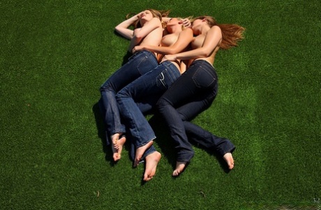 3 topless girls pull their blue jeans down over their bare asses on the lawn