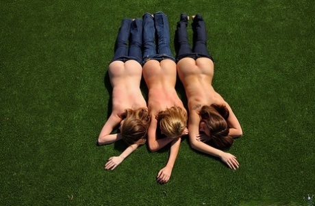 3 topless girls pull their blue jeans down over their bare asses on the lawn