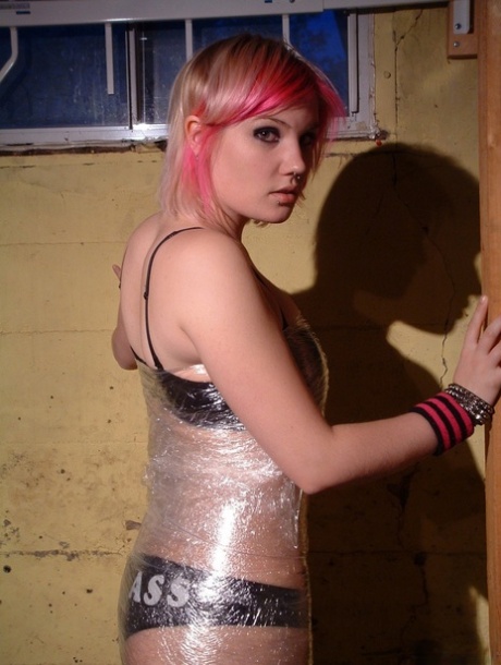 Pink haired fatty rips away plastic wrap to reveal her natural big tits