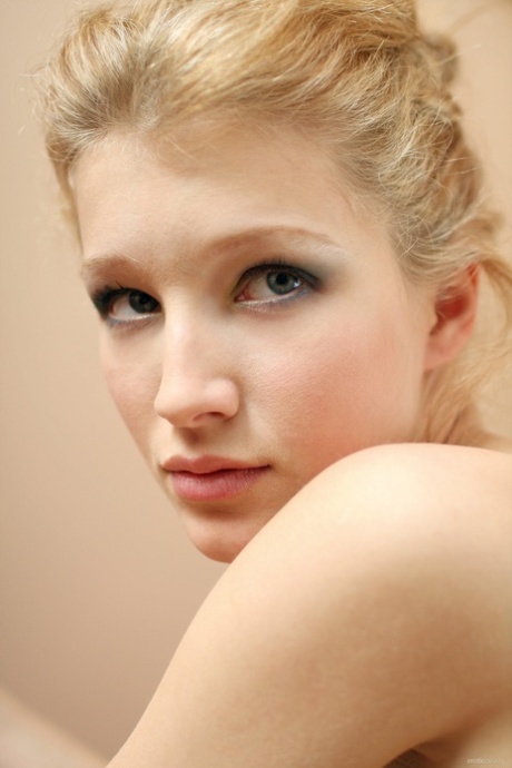 Alluring blonde teen Mila F poses nude and teases with her shaved cunt