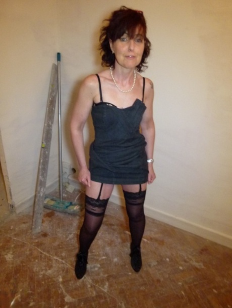 Mature brunette Joyce Mifle strips her clothes & poses in her lingerie