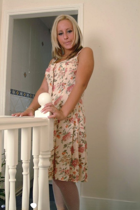 Blonde British doll Natalie Heck strips in the hallway and plays with her cunt
