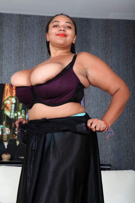Voluptuous ebony Roza strips to her turquoise panties & shows her giant tits