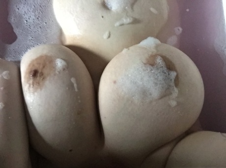 Shameless amateur fatty takes selfies of her big boobs in the bathtub