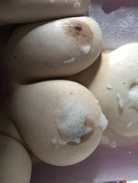 Shameless amateur fatty takes selfies of her big boobs in the bathtub