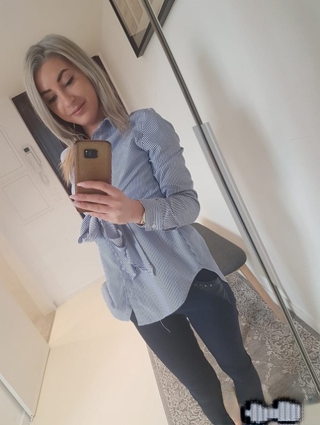 Amateur blonde Ari Fox reveals her small boobs and poses in front of a camera
