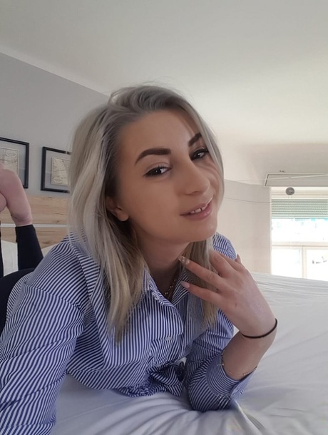 Amateur blonde Ari Fox reveals her small boobs and poses in front of a camera