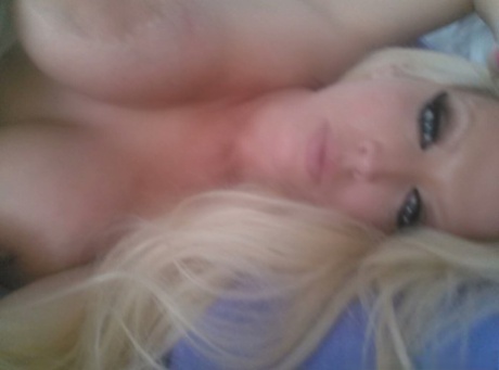 Blonde bombshell Alura Jenson shows her huge boobs and takes selfies at home