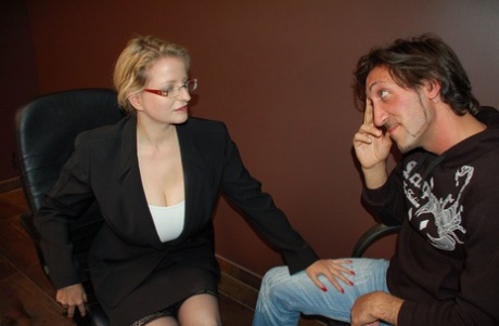 Mature secretary Carola calls her junior to her office and fucks him