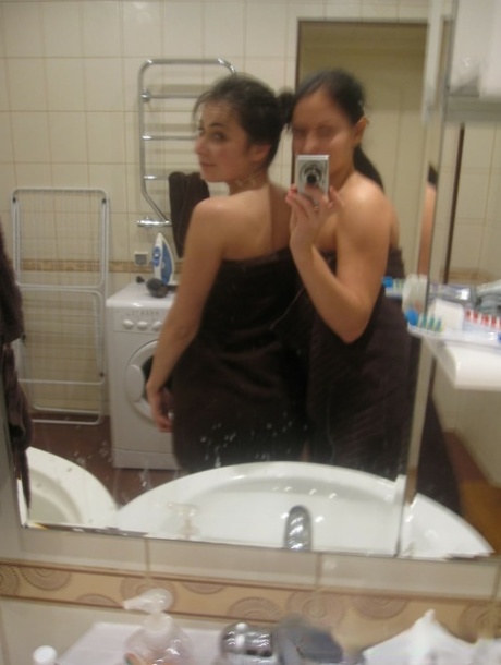 Hot amateur lesbians strip and make out while taking selfies in the bathroom