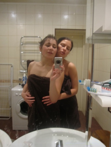 Hot amateur lesbians strip and make out while taking selfies in the bathroom