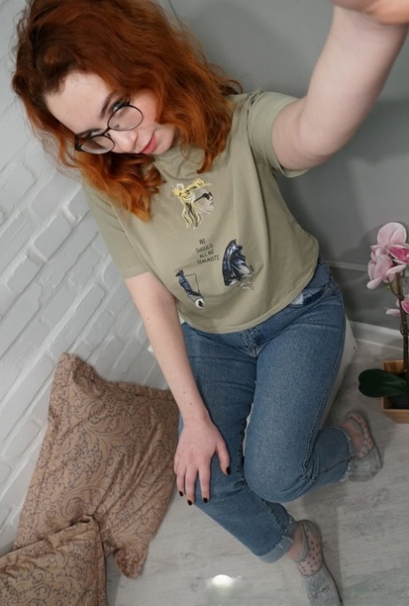 Voluptuous redhead showing off her juicy boobs and booty while taking selfies