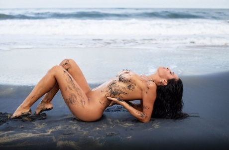Stunning babe Malena Ponce shows off her superb big tits and ass on the beach