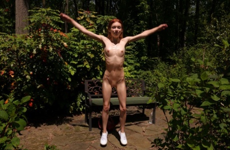 Petite babe Jessica Marie strips naked & stretches her tight pussy outdoors