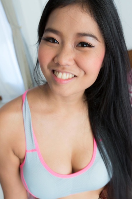 Lovely Asian girl Sanouk shows off her perfect tits & her tight shaved pussy