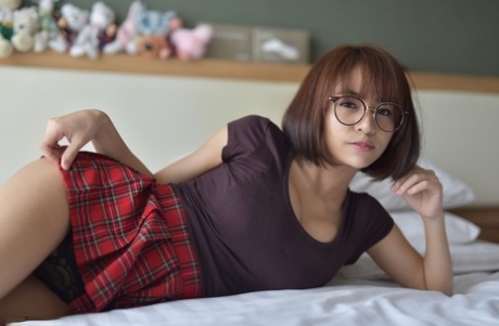 Pretty Asian teen flaunts her hot ass wearing a miniskirt and panties