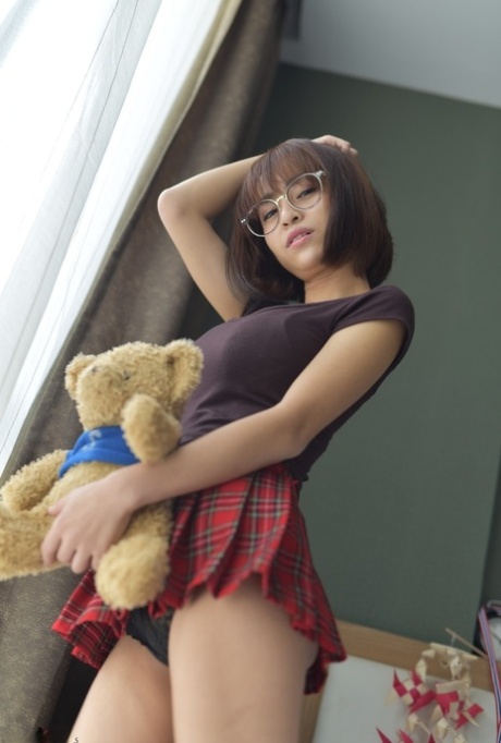 Pretty Asian teen flaunts her hot ass wearing a miniskirt and panties