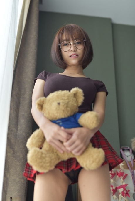 Pretty Asian teen flaunts her hot ass wearing a miniskirt and panties