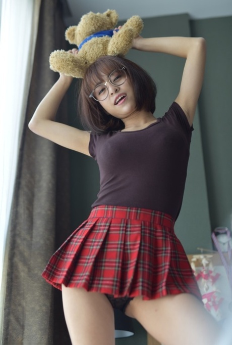 Pretty Asian teen flaunts her hot ass wearing a miniskirt and panties