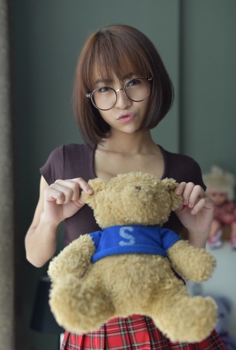 Pretty Asian teen flaunts her hot ass wearing a miniskirt and panties