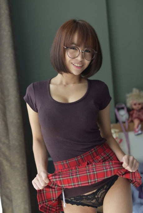 Pretty Asian teen flaunts her hot ass wearing a miniskirt and panties